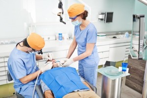 Dental professionals treating a patient in a clinic.