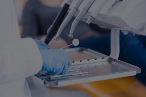 Dental professional preparing tools for a procedure.