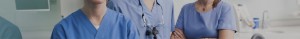 Close-up of medical professional in blue scrubs with stethoscope and magnifying glasses.