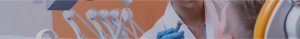 Close-up of a gloved hand handling a medical instrument.
