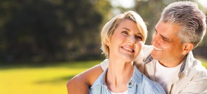 Smiling woman enjoying a sunny day outdoors.