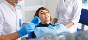 A young woman receiving dental care from a dentist.